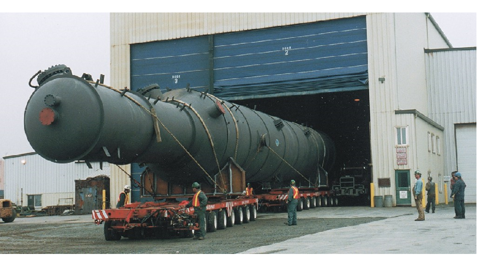 Figure 2:  Examples of pressure vessels in transportation.  The upper images shows a vessel attached to a schnabel train car.  The vessel in the lower image is mounted in saddle supports atop multiple flatbed trailers.